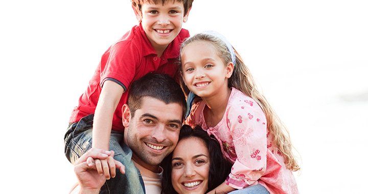 children sit on parents shoulders