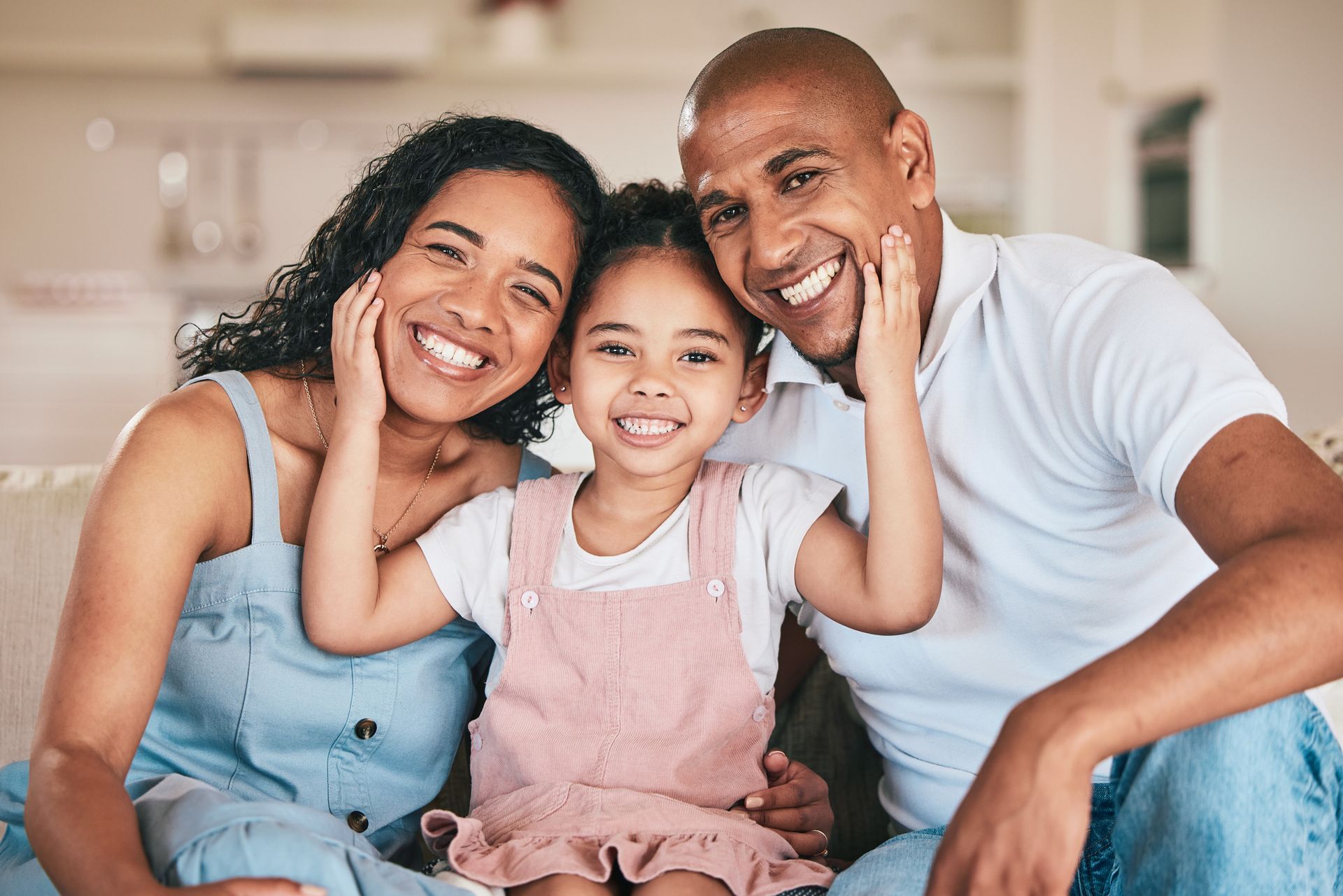 two parents and their child smiling