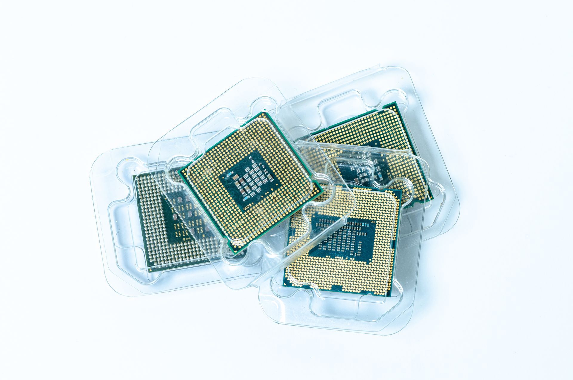 Two trays of electronic components are sitting on top of each other on a table.