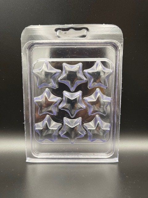 A clear plastic container with stars on it is sitting on a table.