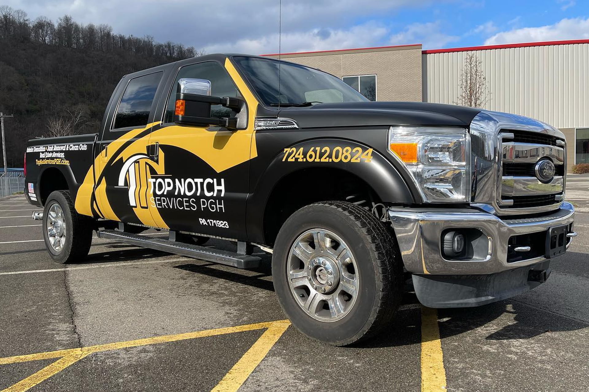 Black pickup truck with gold branding that says