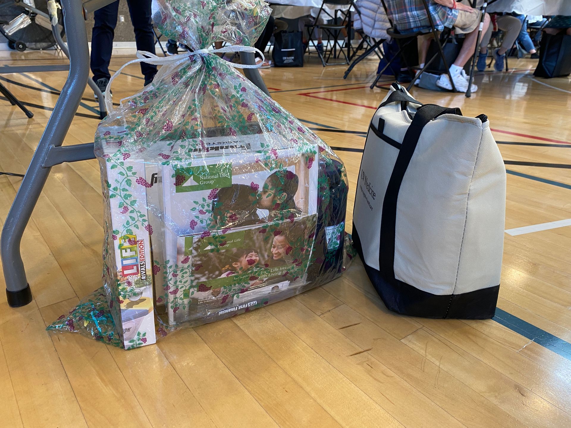A bag and a toy are sitting on a wooden floor.