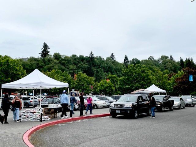 A group of people are standing in a parking lot
