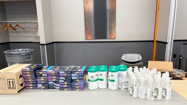A table with a lot of bottles and boxes on it.