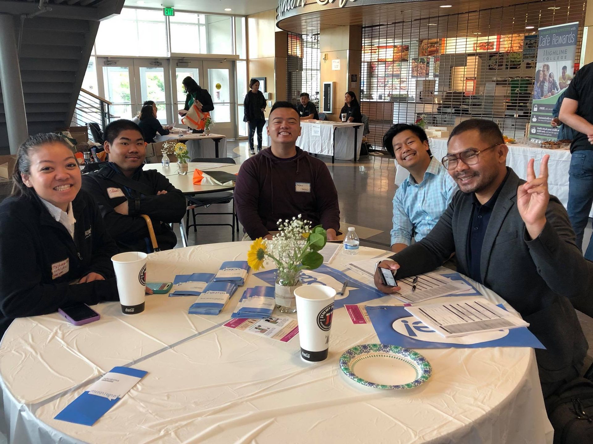A group of people are sitting around a round table.