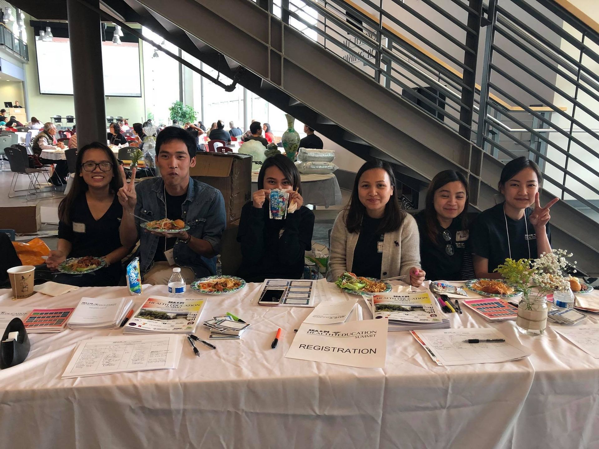 A group of people are sitting at a table eating food.