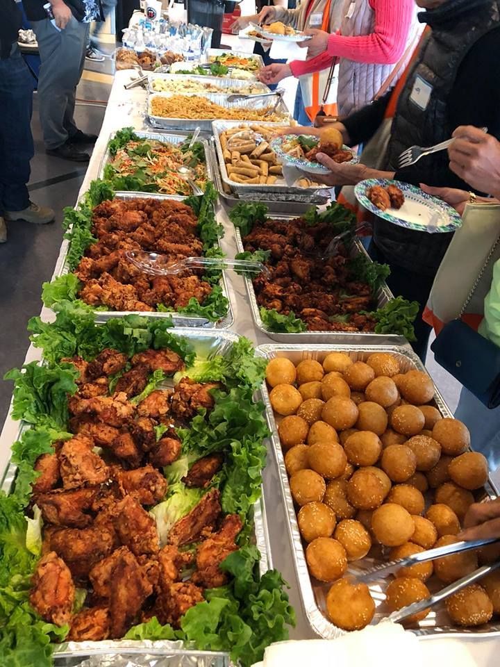 A long buffet table filled with lots of food.