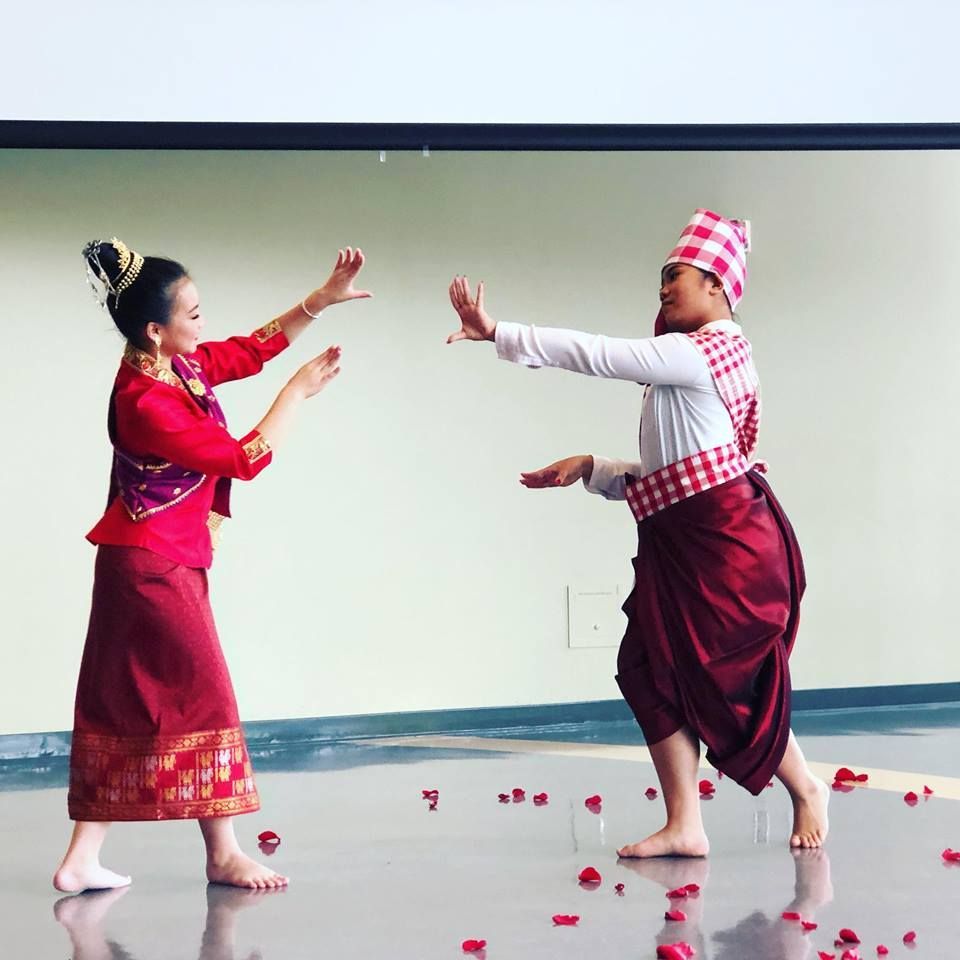 A man and a woman are dancing on a stage