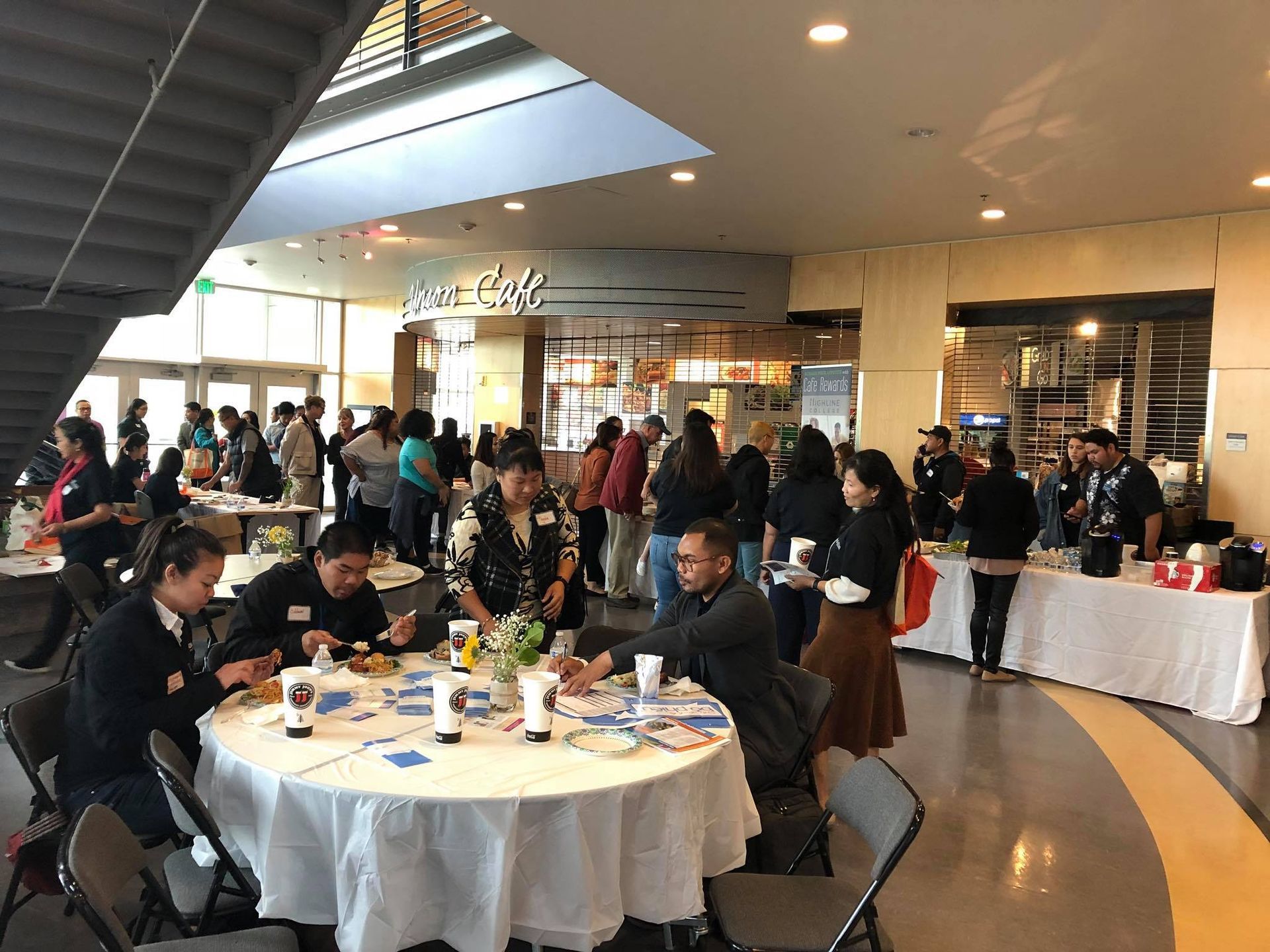 A group of people are sitting at tables in a room.