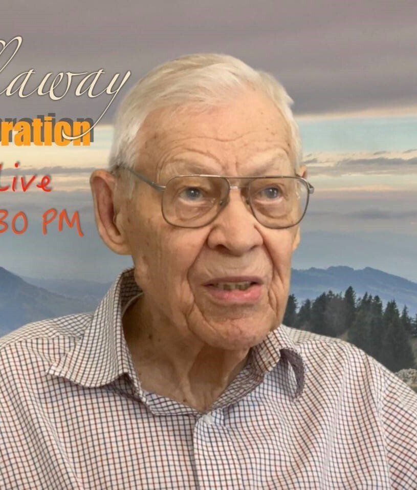 An older man wearing glasses and a plaid shirt