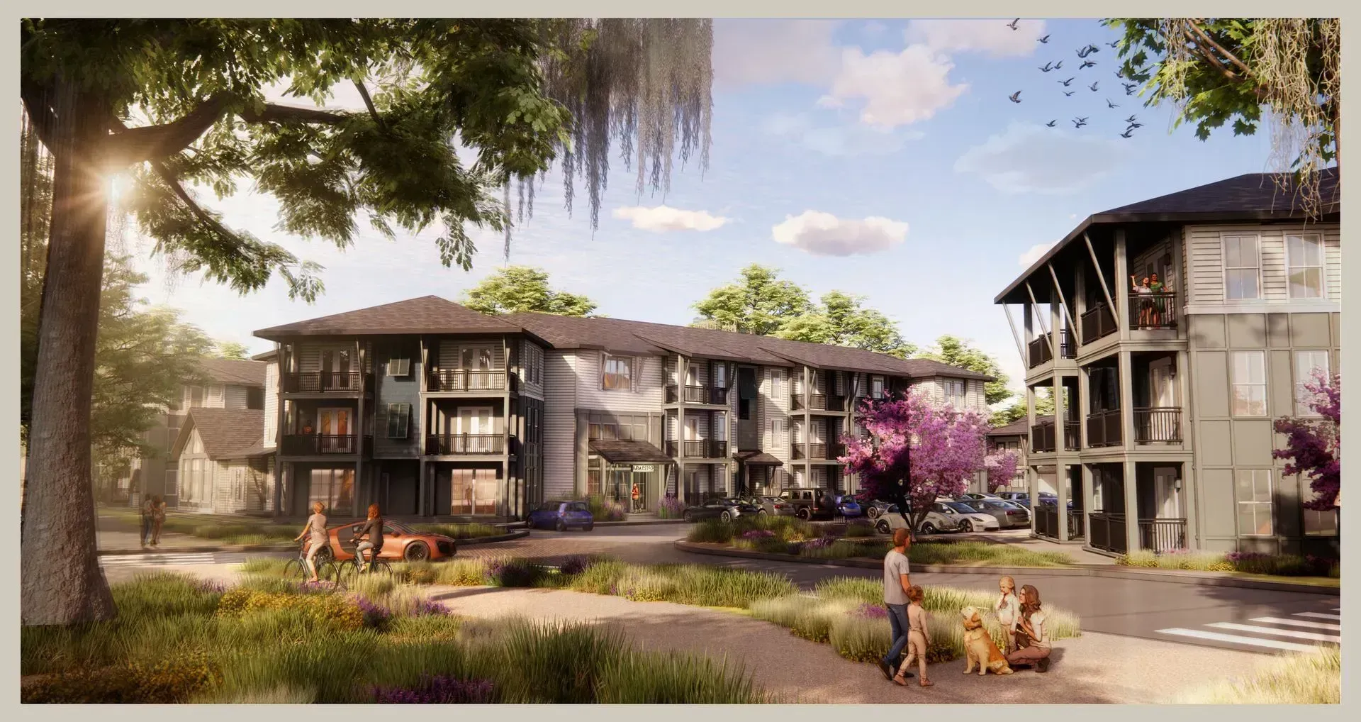 Modern apartment buildings with landscaped courtyard, trees, and people walking along a path