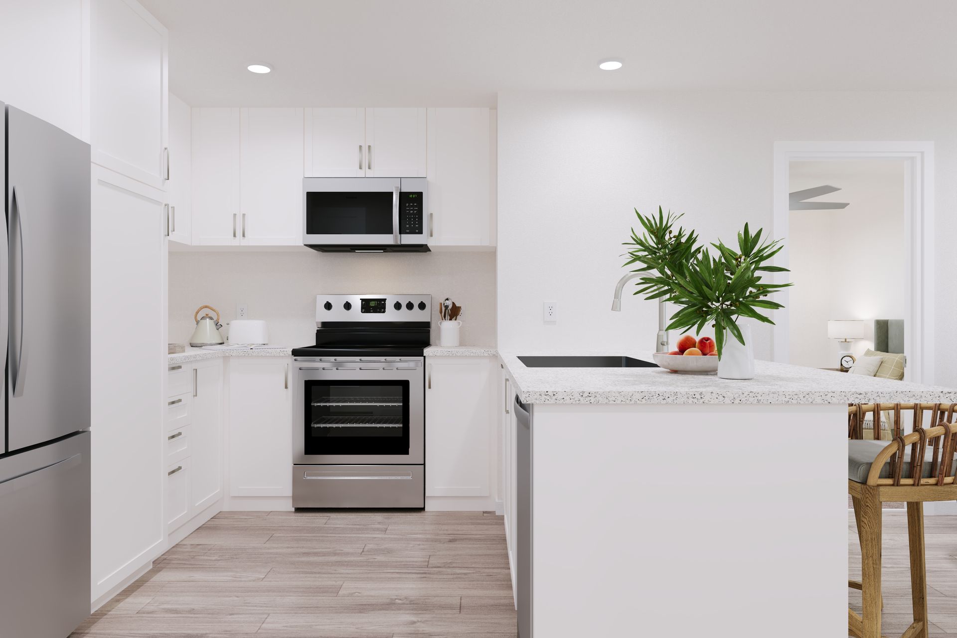 Bright white modern kitchen with stainless steel appliances, island, and potted plant on the counter