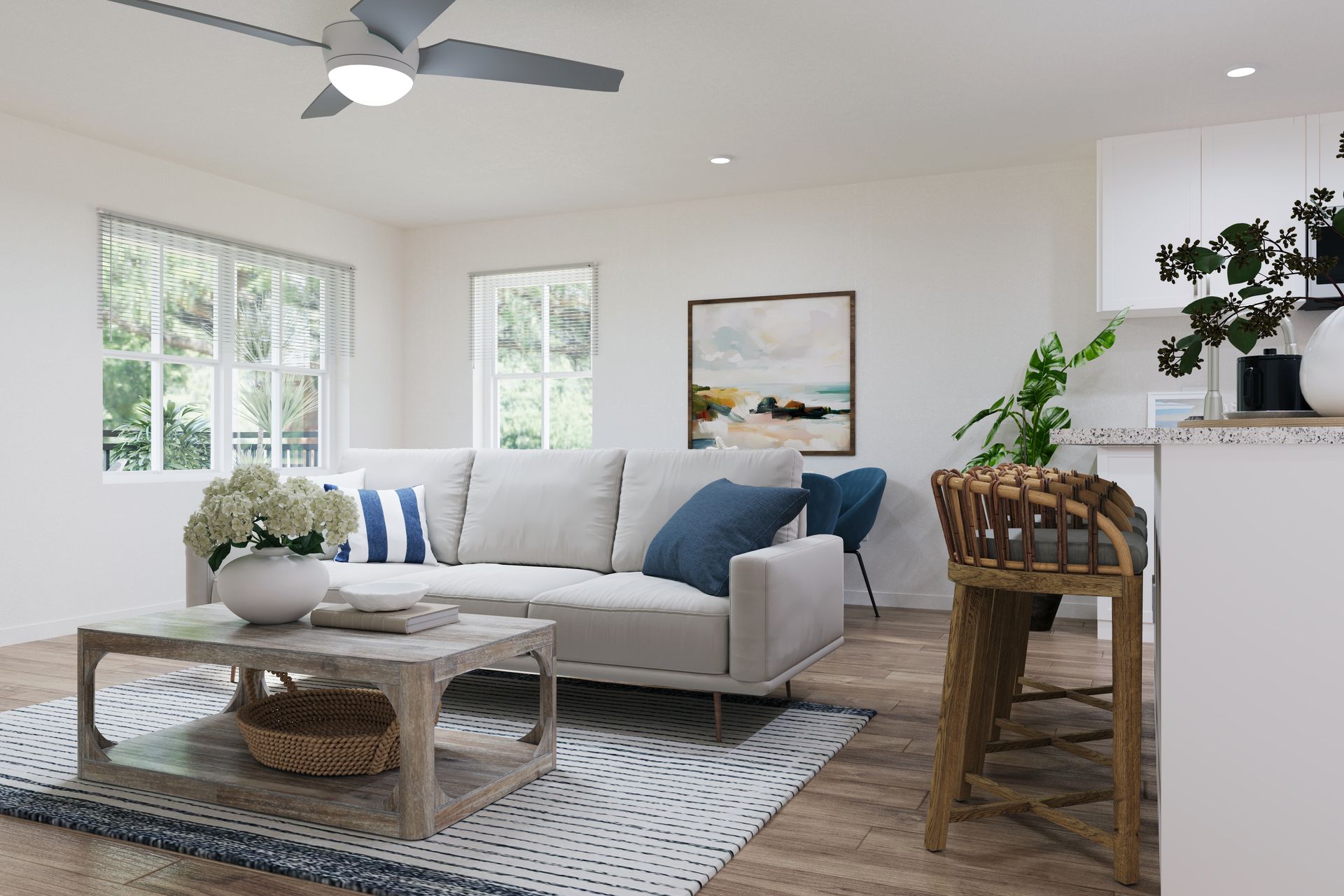 Bright modern living room with white sofa, blue pillows, coffee table, rug, plants, and wood floors