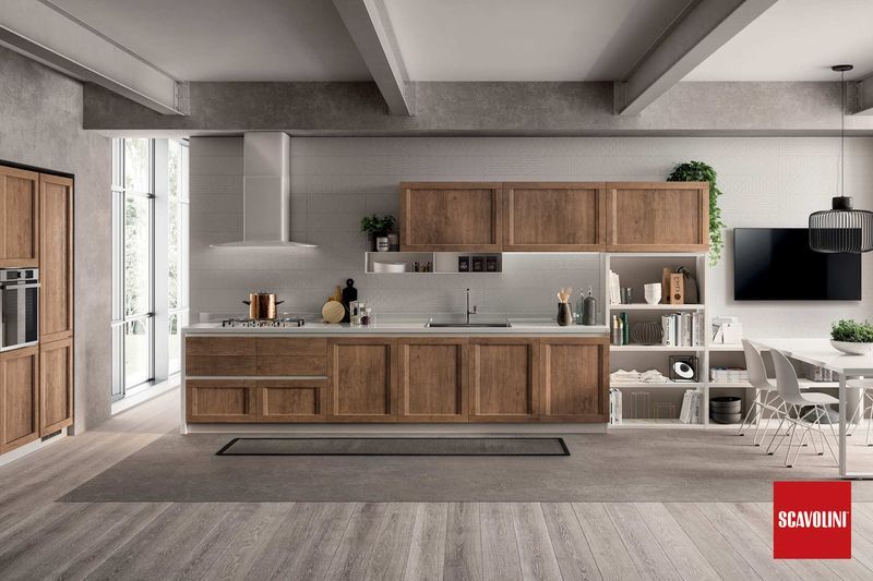 Cucina moderna con mobili in legno, isola centrale, mensole a vista e TV, in un ambiente minimalista sui toni del grigio.