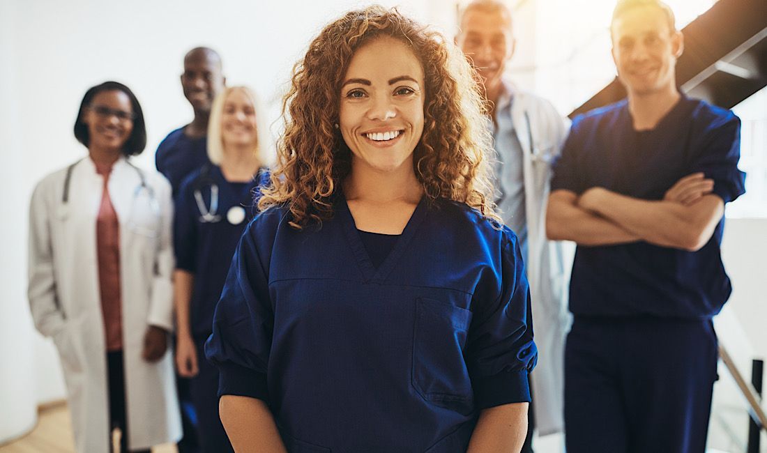 Healthcare staff smiling and looking friendly.