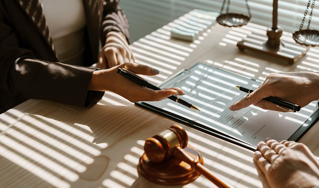 Two people at a desk reviewing a medical malpractice lawsuit, legal representation in Pittsburgh, PA.
