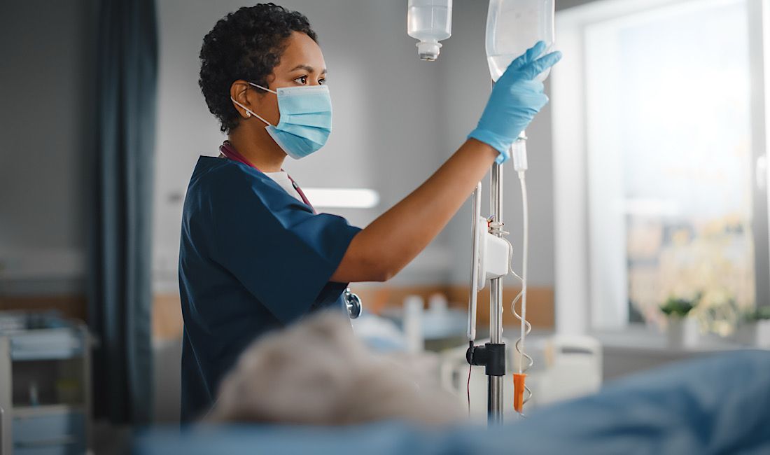 Nurse caring for patient with MRSA, infectious disease, Pittsburgh, PA