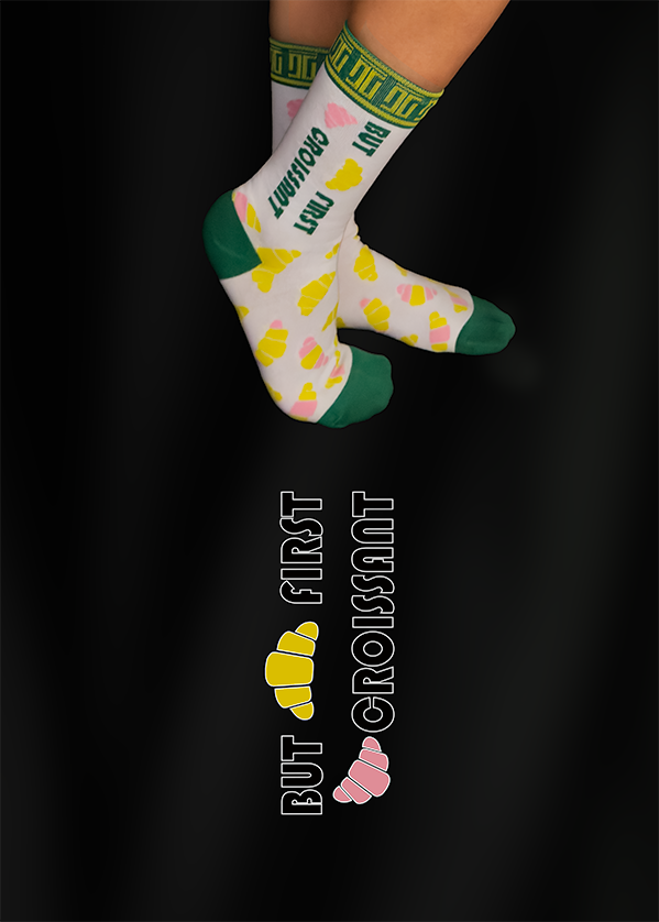 Pair of socks with a croissant pattern and text