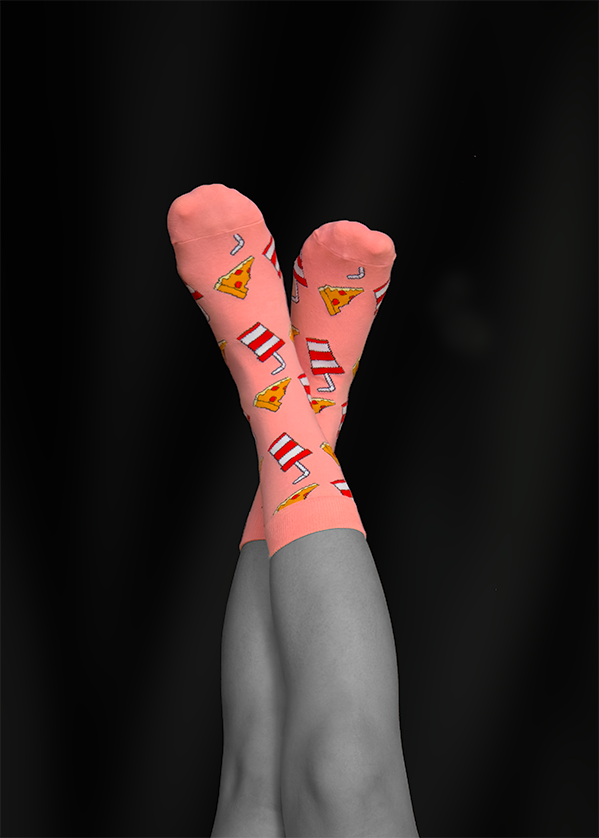 Pink socks with pizza and fries pattern, legs crossed against a black background.