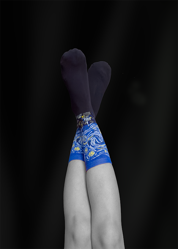 Crossed legs wearing blue patterned socks against a black background.