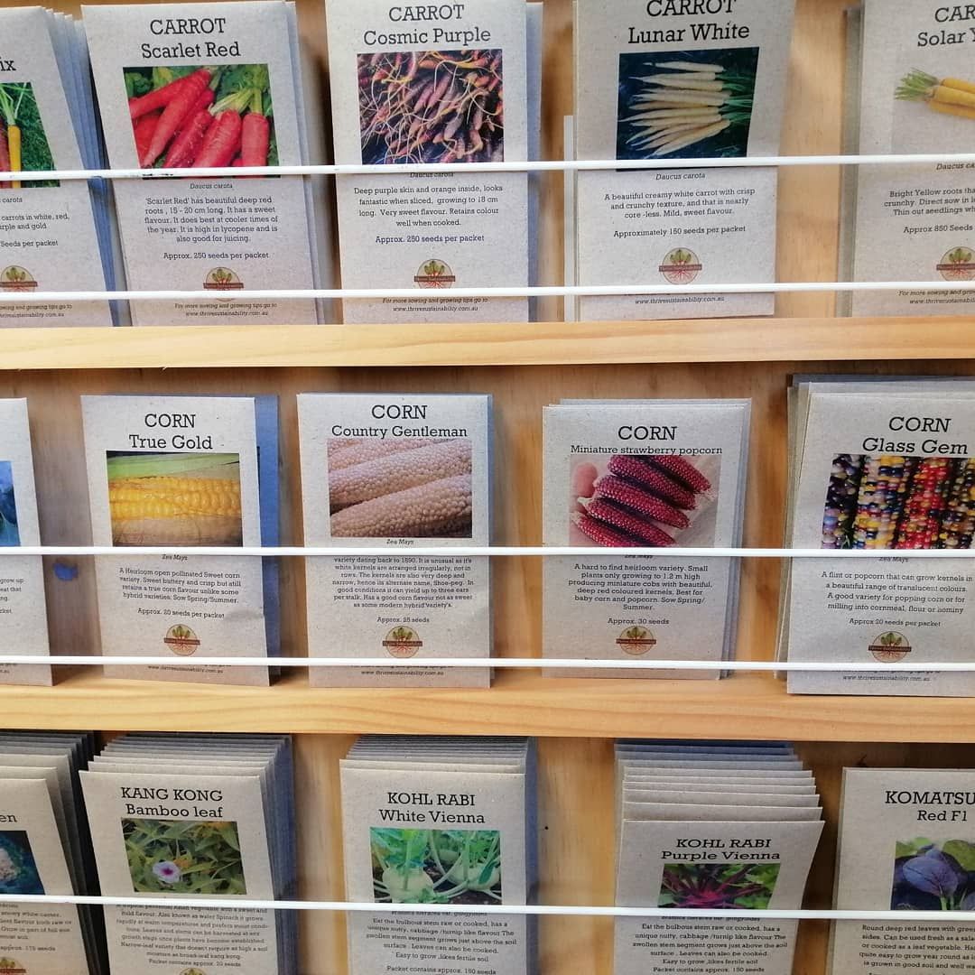 A shelf full of seed packets including corn