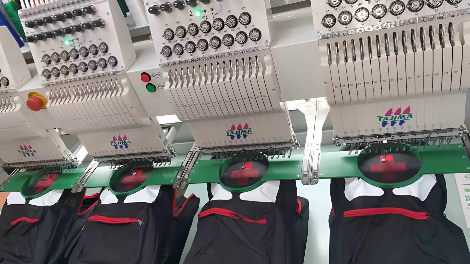 A Row Of Backpacks Are Being Embroidered On A Machine — Gympie Embroidery Services In Southside, QLD