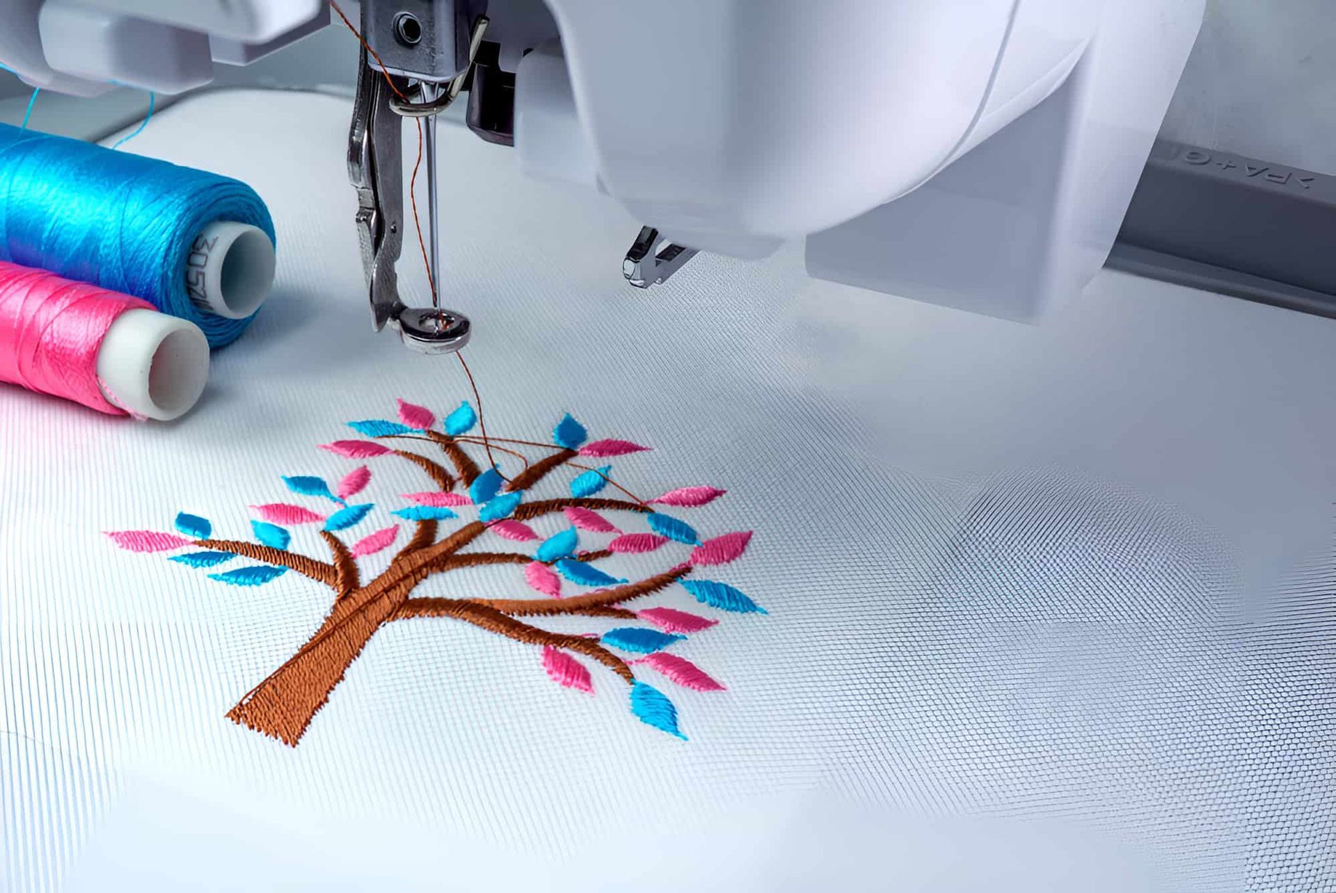 A Sewing Machine Is Embroidery A Tree On A Piece Of Fabric — Gympie Embroidery Services In Southside, QLD