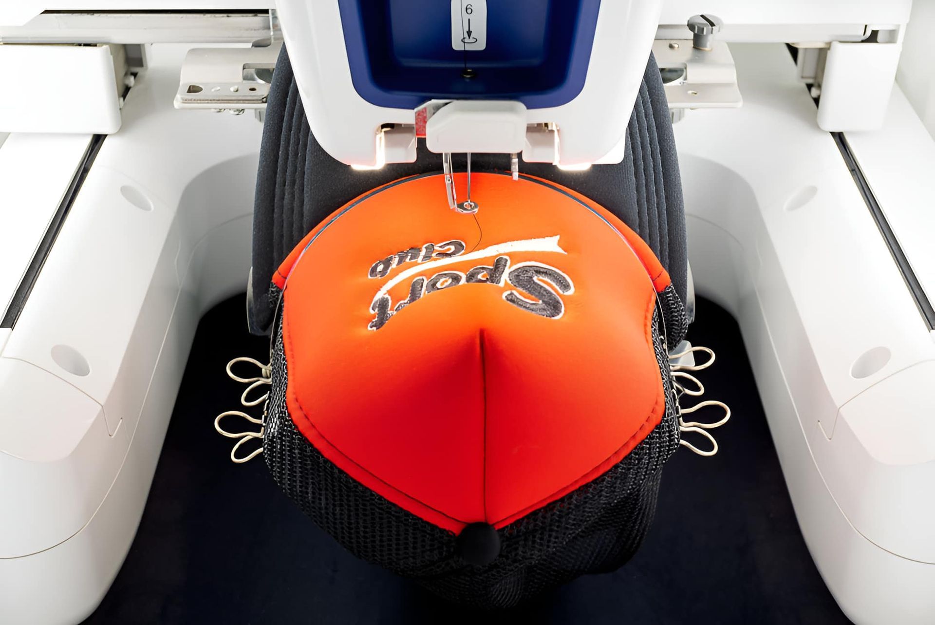 A Hat Is Being Embroidered — Gympie Embroidery Services In Southside, QLD