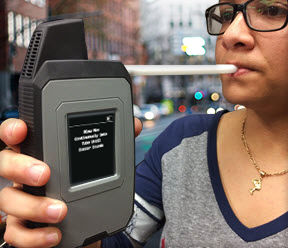 A woman wearing glasses is holding a cell phone in her hand