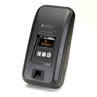 A black device with buttons on it is sitting on a white surface.