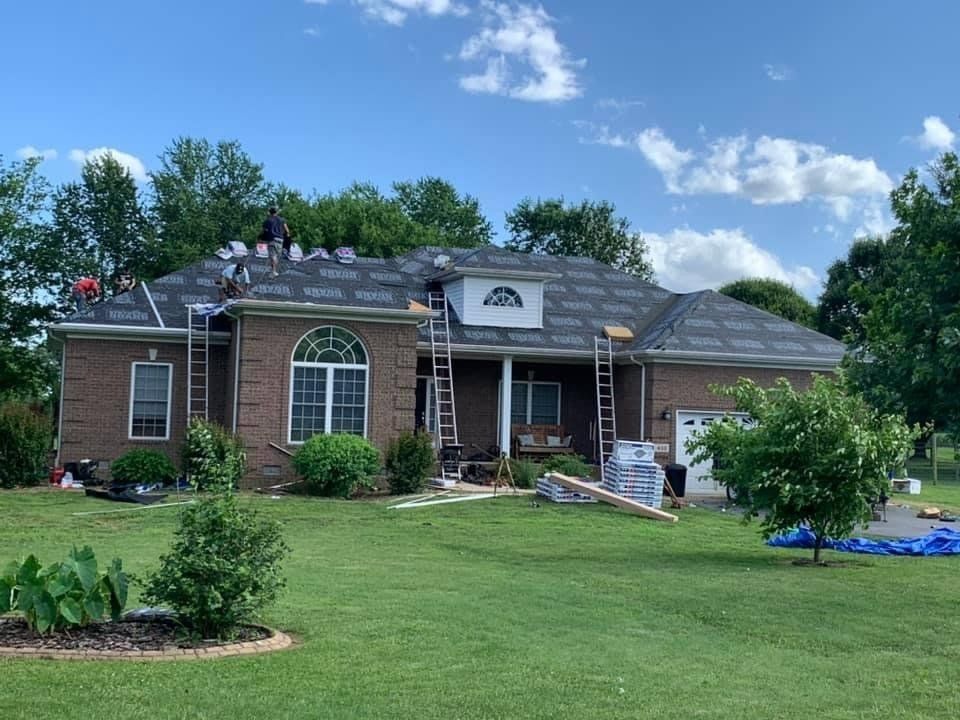 Roofers working on a house. 