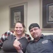 A man and a woman are sitting next to each other on a couch.