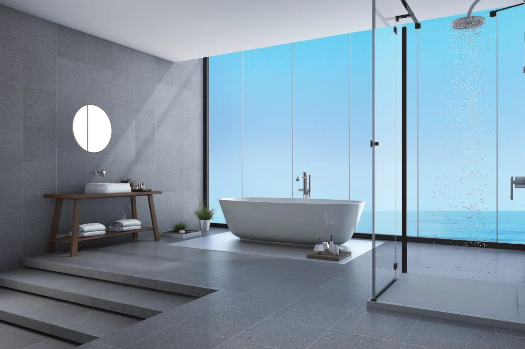 Salle de bains moderne de type spa avec baignoire îlot, douche à effet pluie, marches en pierre et vue sur l'océan