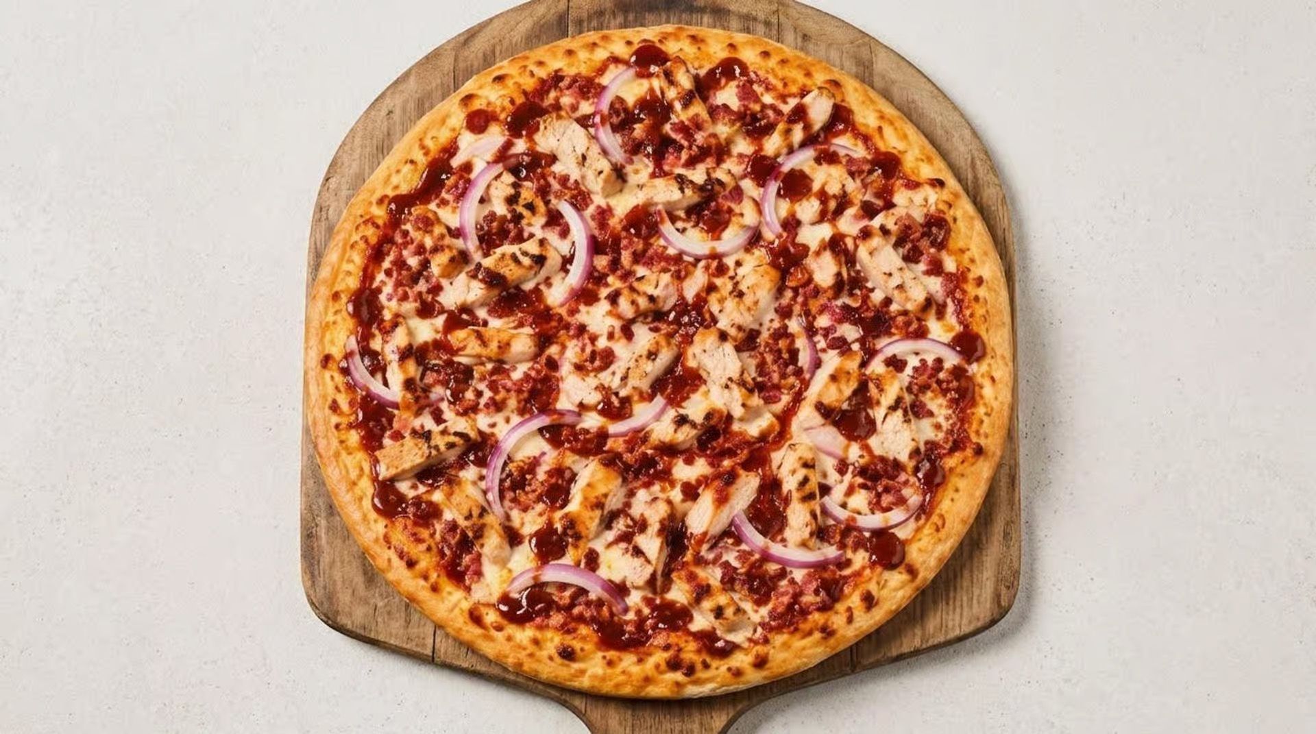 Top-down view of a pepperoni pizza on a wooden board against a light background