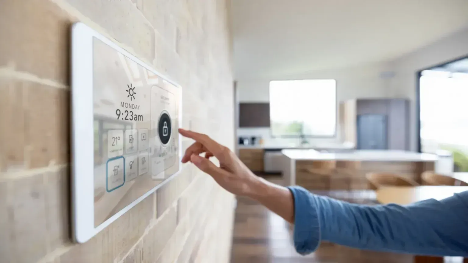 Hand adjusting a wall-mounted smart thermostat in a bright living room
