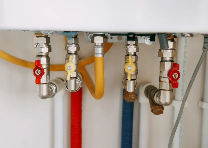 Under-sink plumbing with multiple shutoff valves, flexible hoses, and color-coded pipes