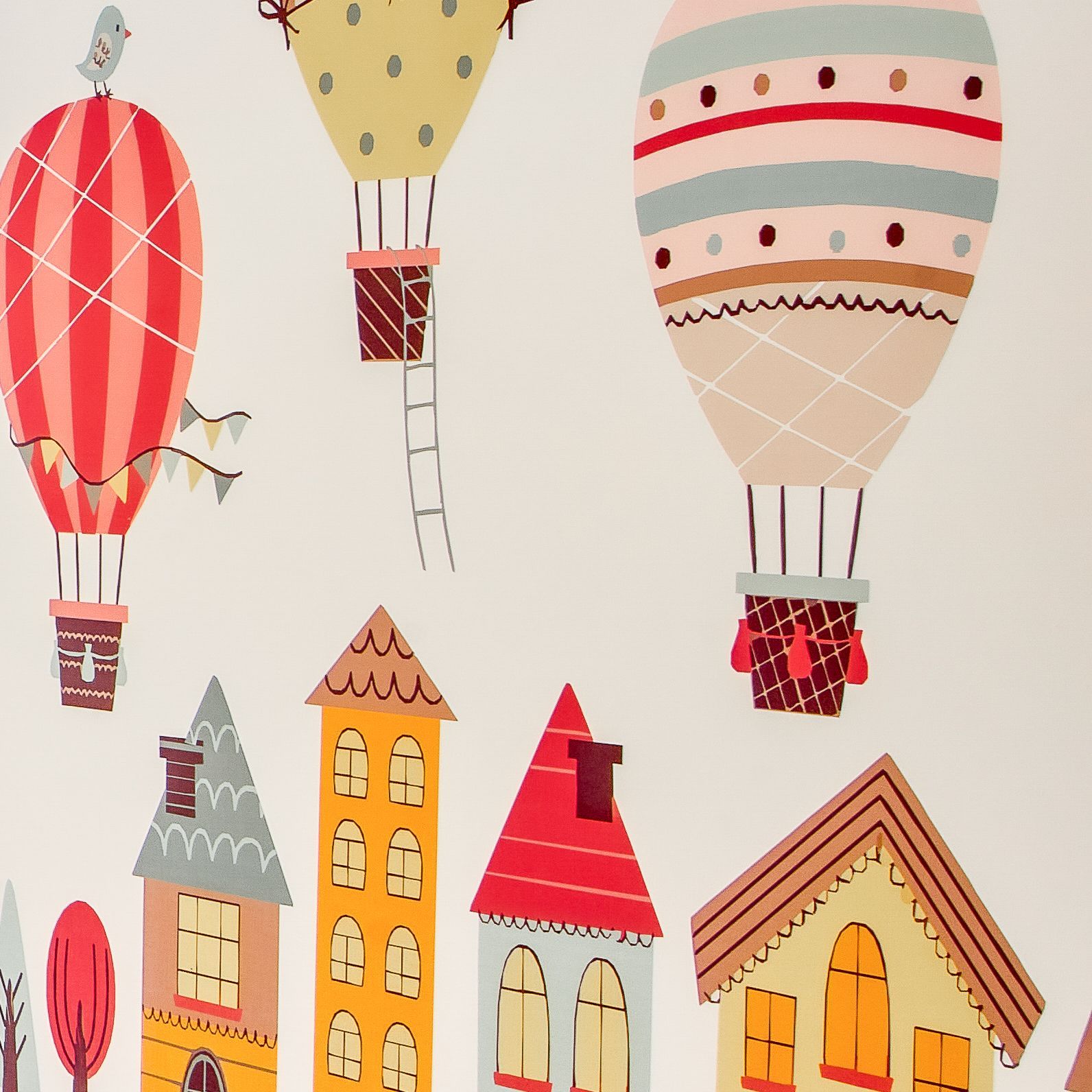 Colorful illustrated hot air balloons and whimsical houses on a light background