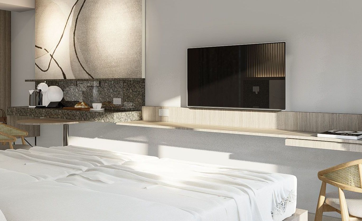 A bedroom with a bed, television, desk and chair for an affordable staycation in Quezon City