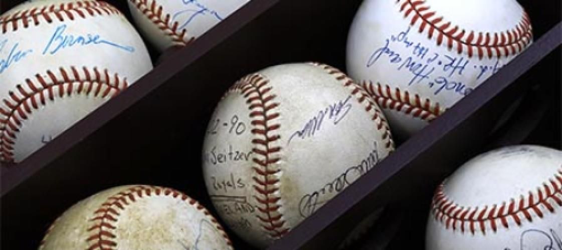 A bunch of baseballs with signatures on them