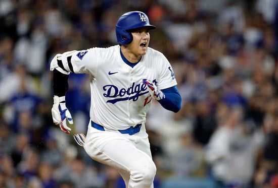 A baseball player is running towards home plate during a game. A baseball player is running towards home plate during a game.