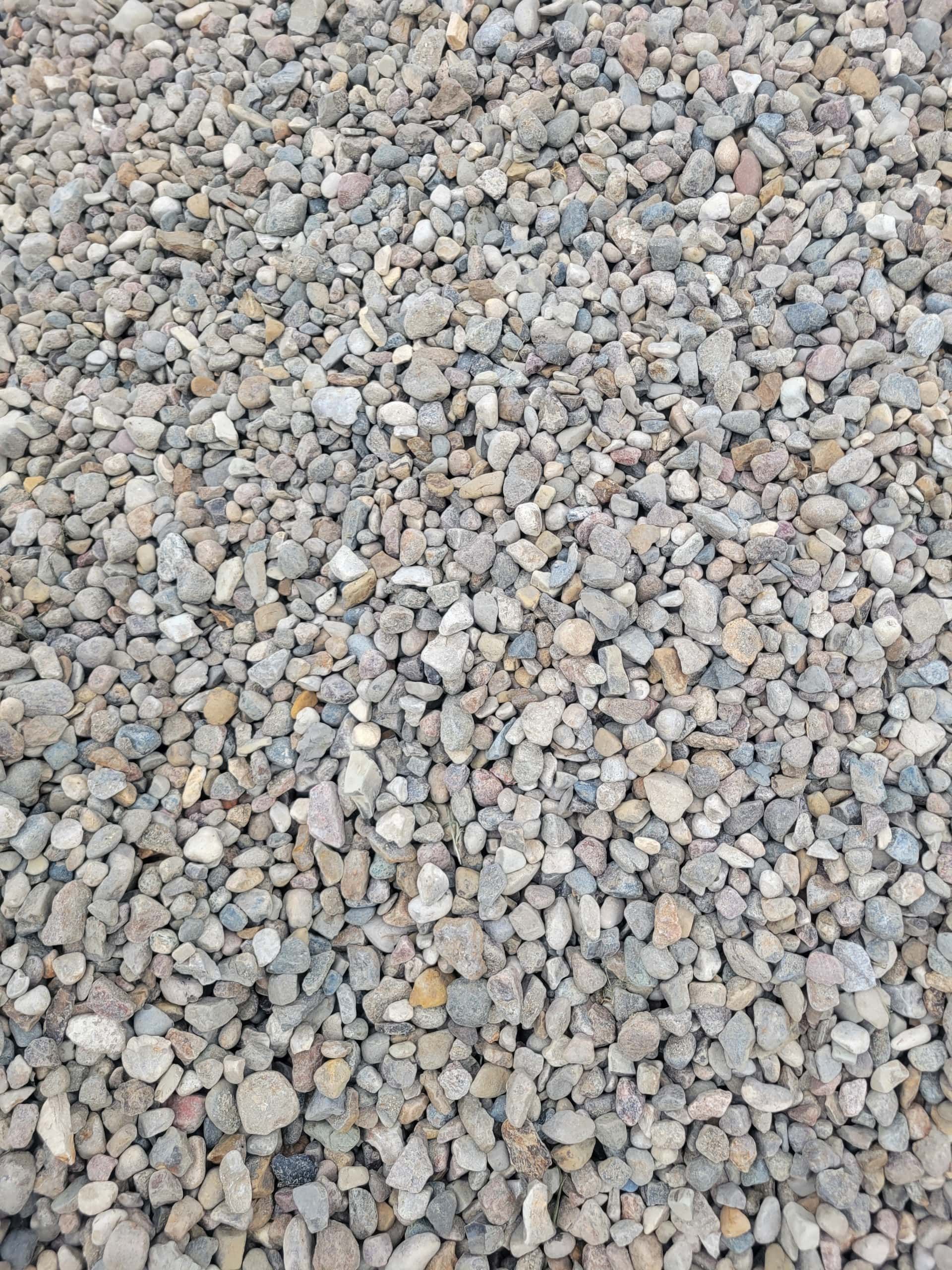 Gravel: Mixture of small, rounded, grey, and tan stones, likely used for landscaping or construction.