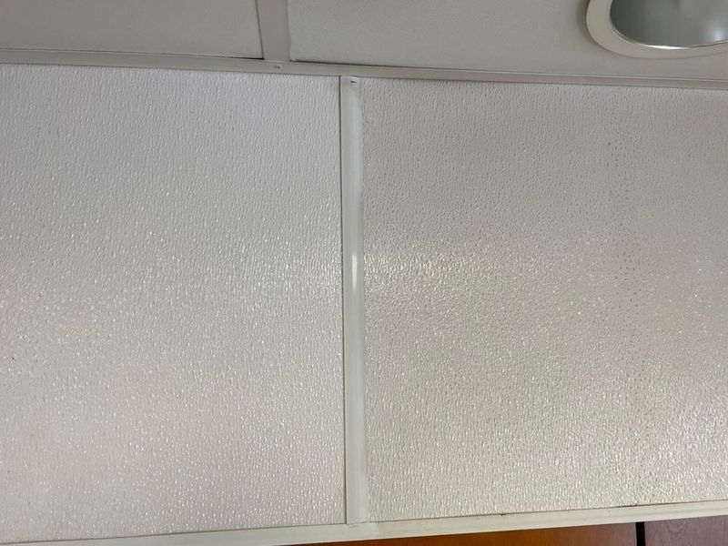 White textured wall panels with a vertical strip, mounted in a room.
