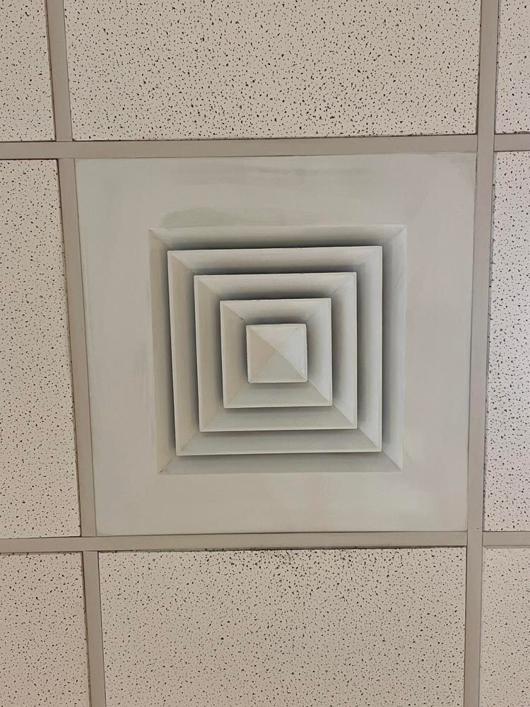 White square ceiling air vent.