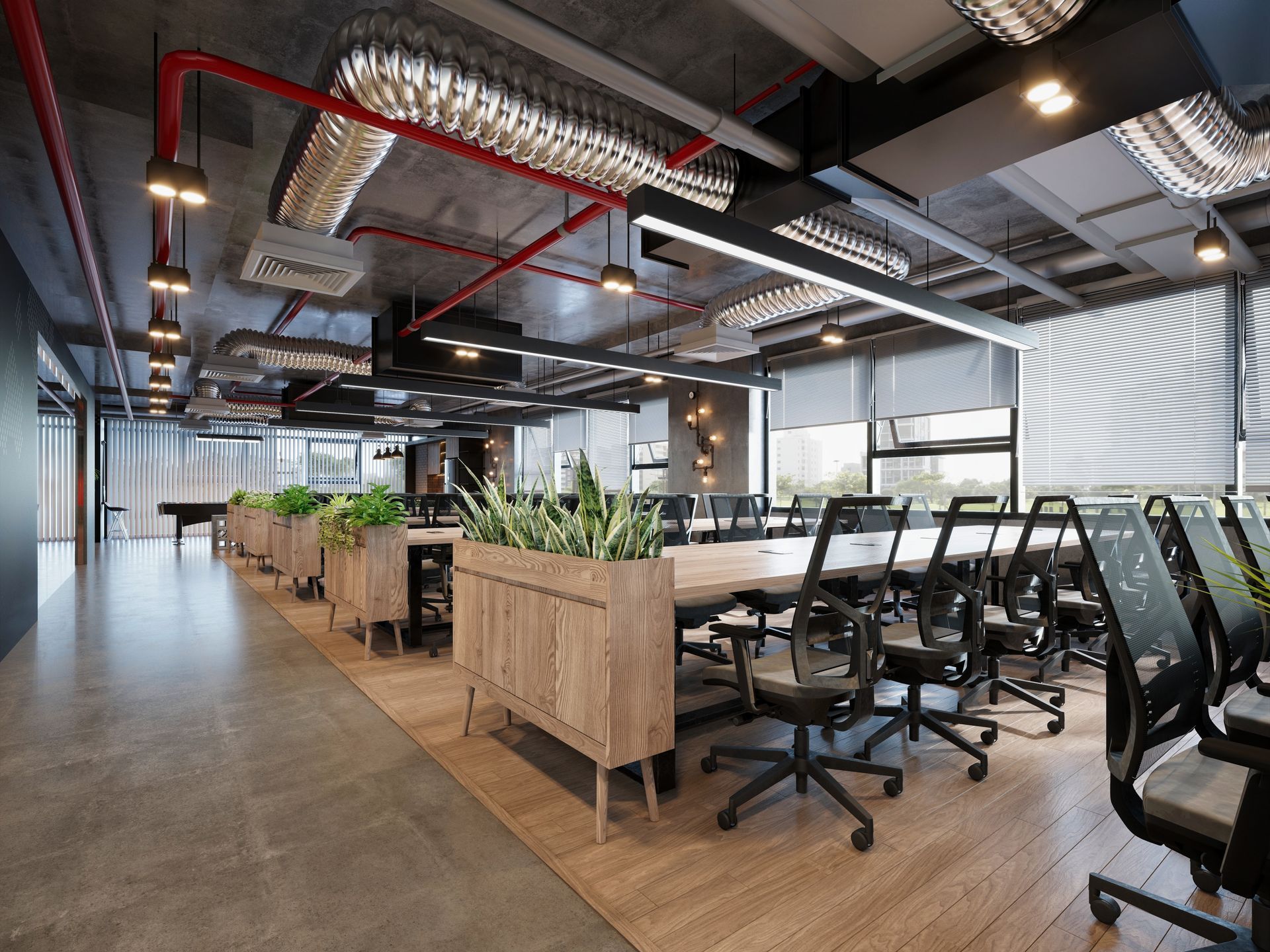Modern office space with desks, plants, and open ceiling.