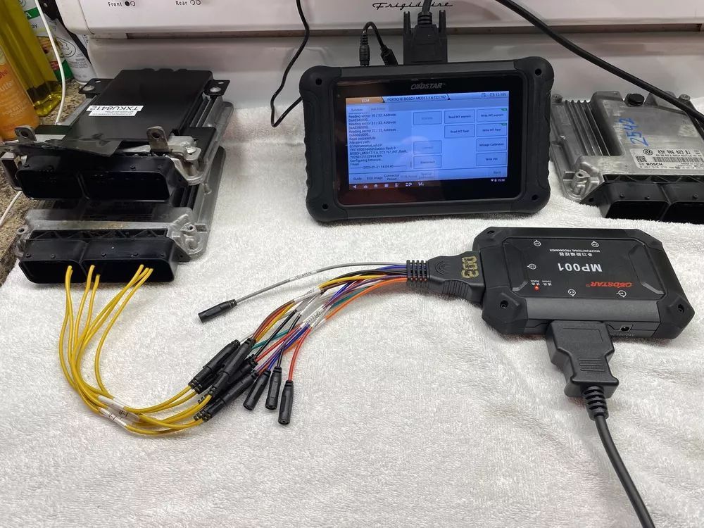 A bunch of wires are connected to a device on a table.