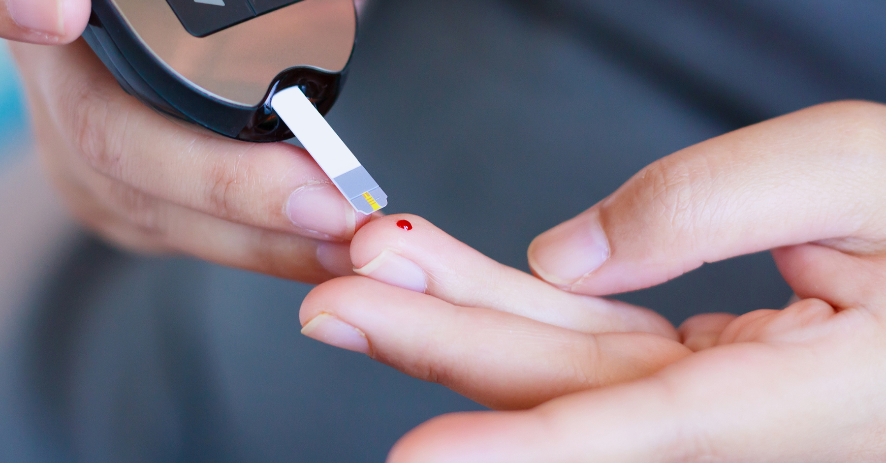 Fingerstick blood glucose test being performed, illustrating screening and monitoring practices for gestational diabetes.
