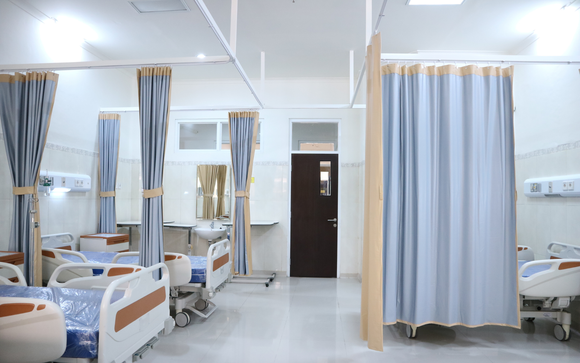 Hospital room with several empty hospital beds