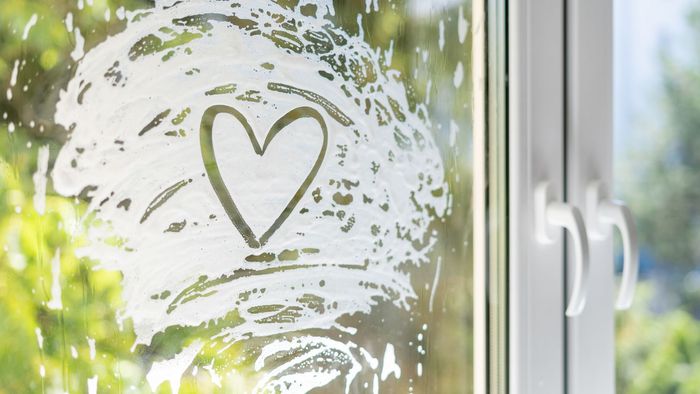 A heart is drawn on a window with a brush.