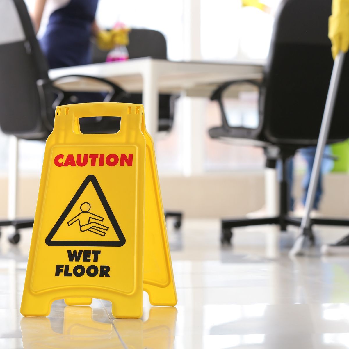 A yellow sign that says caution wet floor