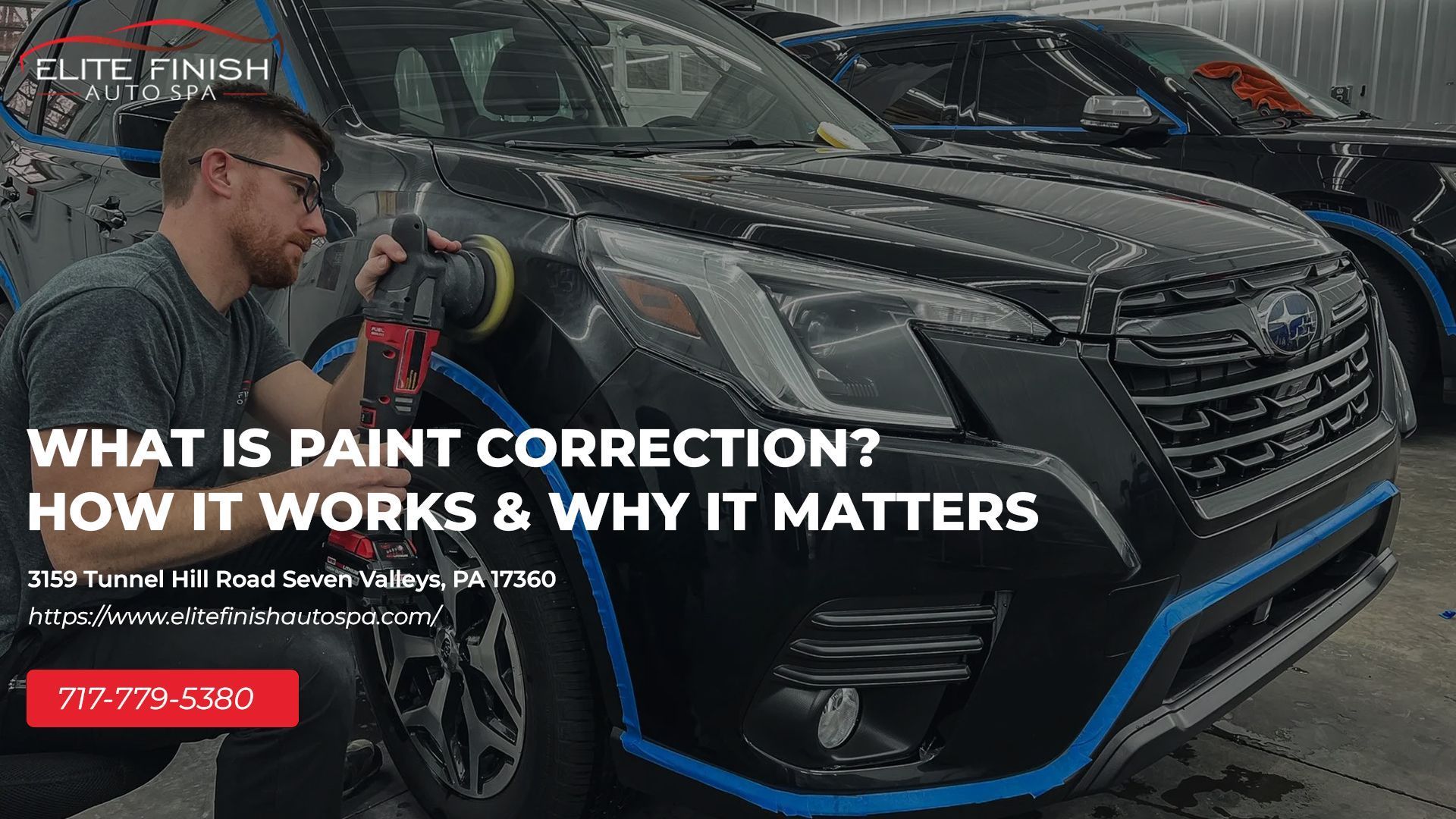 A man is polishing the front of a black car.